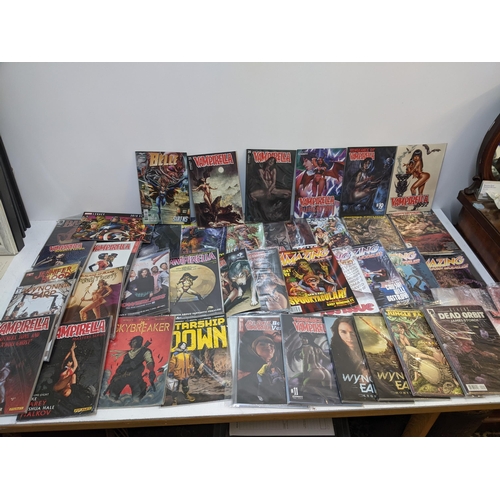 68 - A collection of modern comics to include several editions of Vampirella, Jungle Fantasy, Amazing Fig... 