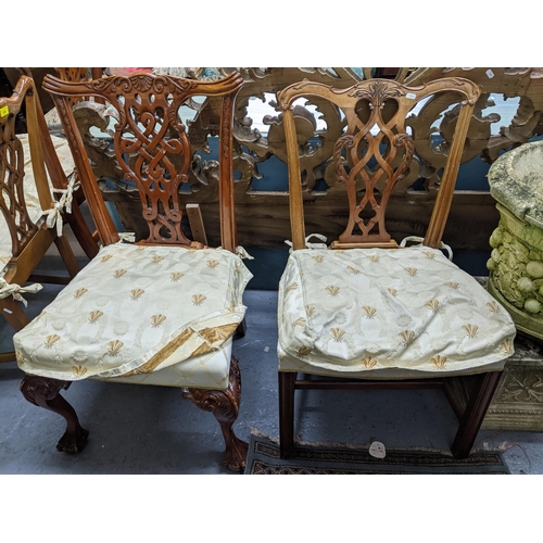 103 - A set of four Frank Hudson of High Wycombe reproduction mahogany dining chairs with upholstered over... 