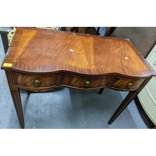 97 - A reproduction mahogany serpentine fronted three-drawer side table on square tapering legs 78cm x 93... 