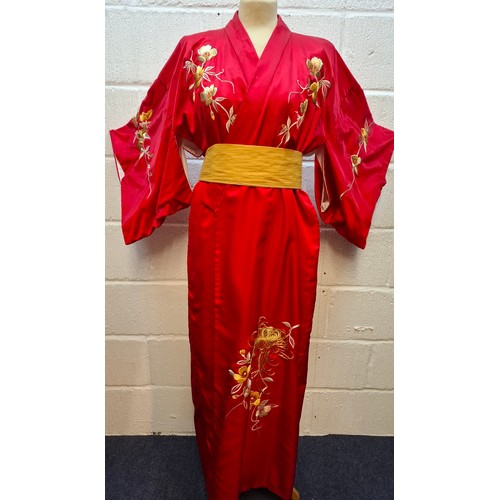 A late 20th Century Japanese red silk embroidered robe with mustard yellow sash belt and embroidered peacock to the rear, approx 38" chest x 56" long. Location:RWB
Condition:Some spillage stains and an area where the thread is unravelling-see additional photos