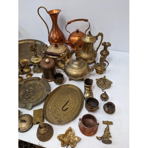 13 - A collection of metalware to include two brass kettles, two trays, a copper water jug and kettle, a ... 