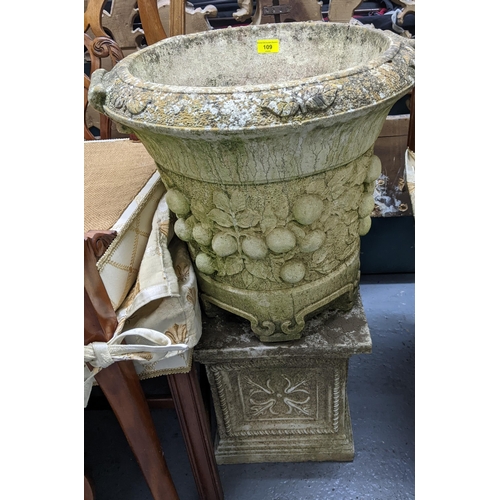 109 - A Willowstone weathered garden concrete planter with twin cast scroll handles, raised relief fruit a... 