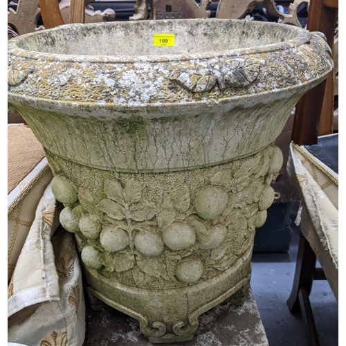 109 - A Willowstone weathered garden concrete planter with twin cast scroll handles, raised relief fruit a... 