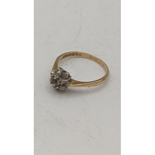 63 - An 18ct yellow and white gold ladies ring fashioned as a flower head set with white sapphires, centr... 