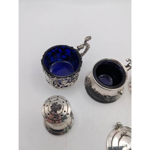 119 - Four silver condiments to include a pepper pot, salts and two mustard pots A/F, total weight excludi... 