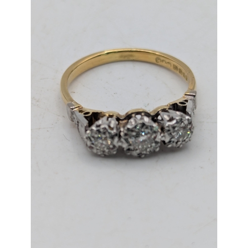 82 - An 18ct white and yellow gold three-stone diamond ring in an illusion setting, size N, 3.3g Location... 