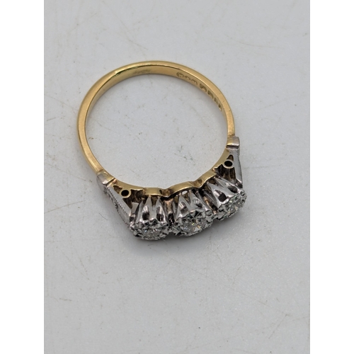 82 - An 18ct white and yellow gold three-stone diamond ring in an illusion setting, size N, 3.3g Location... 