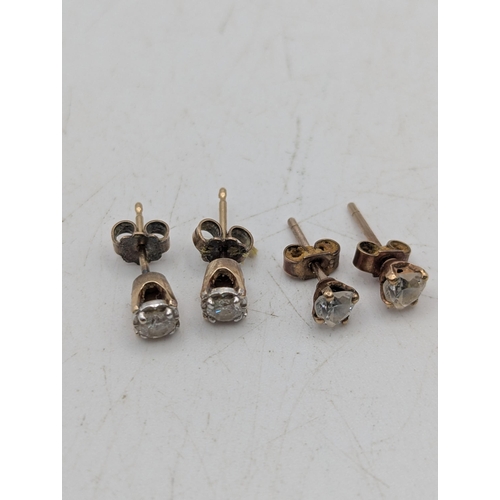 92 - Two pairs of stud earrings to include a pair of diamond yellow and white metal earrings, tested as 9... 
