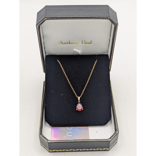 96 - A pear shaped garnet pendant in a three claw setting mounted in 9ct yellow gold on a 9ct yellow gold... 