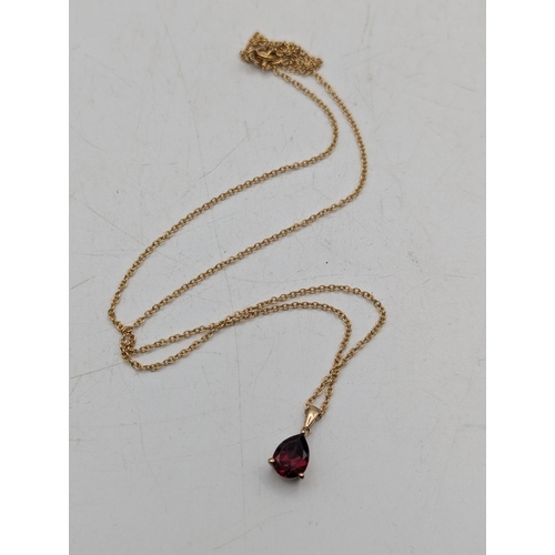 96 - A pear shaped garnet pendant in a three claw setting mounted in 9ct yellow gold on a 9ct yellow gold... 