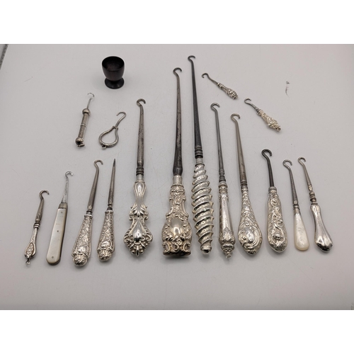 A collection of mainly silver handled button hooks having floral ...
