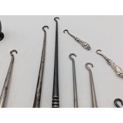 A collection of mainly silver handled button hooks having floral ...