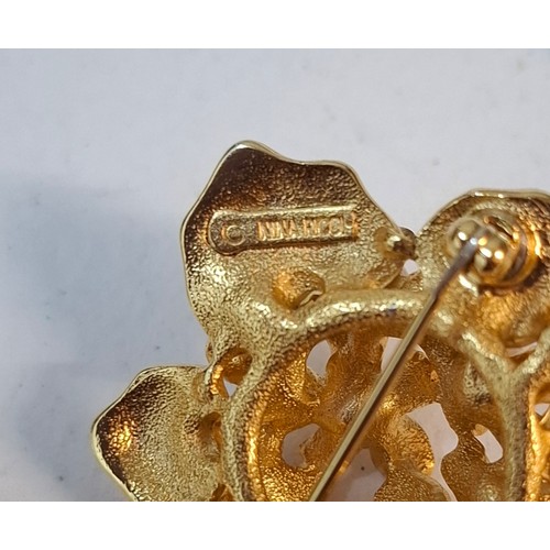 5 - YSL- A small lot comprising an Yves Saint Laurent gold tone leaf brooch, a gold tone Nina Ricci flor... 