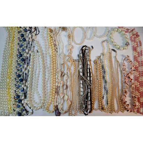 50 - A quantity of 1970's and later bead necklaces and bracelets to include Aurora Borealis necklaces, fa... 