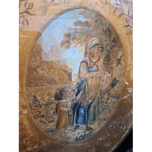 31 - A Georgian silk and embroidered ebony framed picture of a mother and child 28.5cm wide x 36cm high b... 