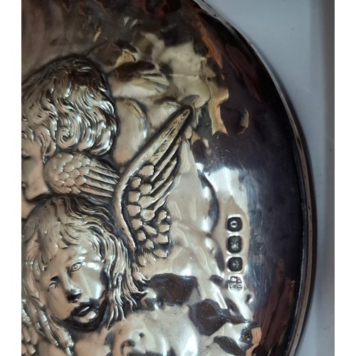 48 - A silver 2-piece dressing table set featuring a cherubic design together with a silver clothes brush... 