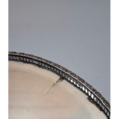 48 - A silver 2-piece dressing table set featuring a cherubic design together with a silver clothes brush... 