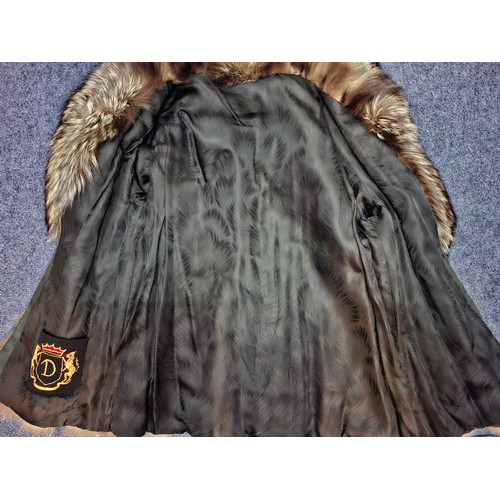 44 - A late 20th century wolf fur jacket with internal pocket embroidered with the letter 'D' and a coat ... 