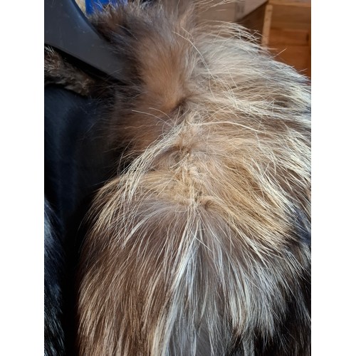 44 - A late 20th century wolf fur jacket with internal pocket embroidered with the letter 'D' and a coat ... 