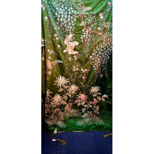 46 - A 1920's hand-made green silk bed spread having embroidered images of birds amongst fuchsias, branch... 