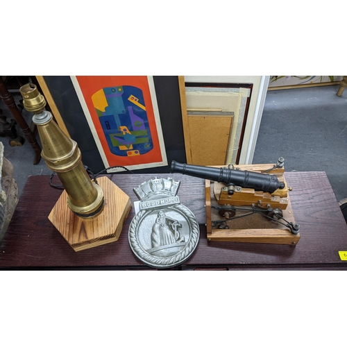 650 - A cast metal and wooden model canon, a cast iron Good Hope plaque and a brass fire-hose nozzle conve... 