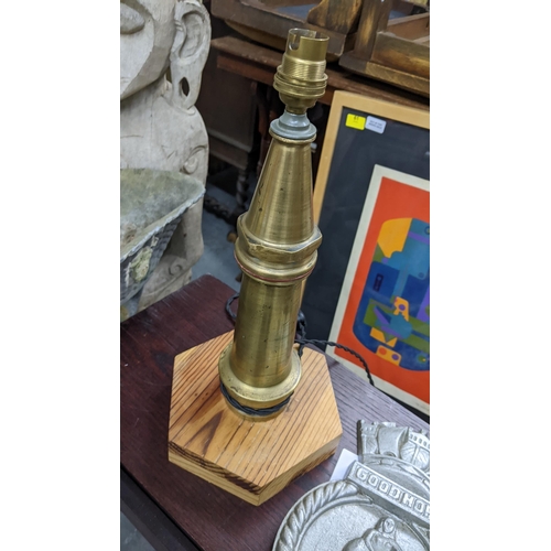 650 - A cast metal and wooden model canon, a cast iron Good Hope plaque and a brass fire-hose nozzle conve... 