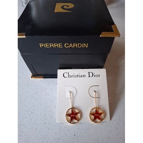 15 - Christian Dior- A pair of late 20th Century gold tone and red enamel star earrings with Dior to the ... 