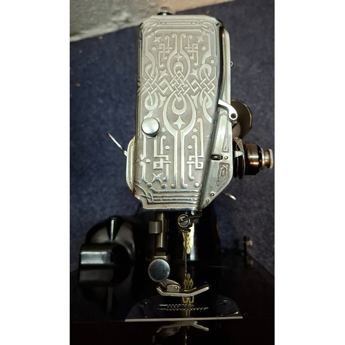 37 - A 1951 Singer 221K electric featherweight sewing machine in original fitted case with accessories an... 