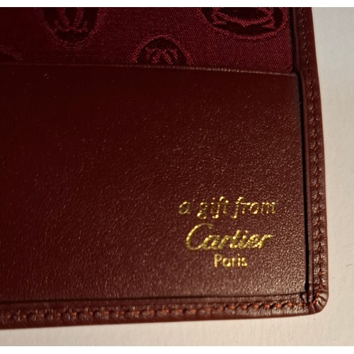 9 - Cartier- A Must de Cartier burgundy leather single card/mirror wallet with original box and fabric p... 