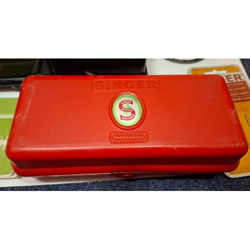 38 - A 1957 Singer Featherweight 222K electric sewing machine having a black travel case together with a ... 
