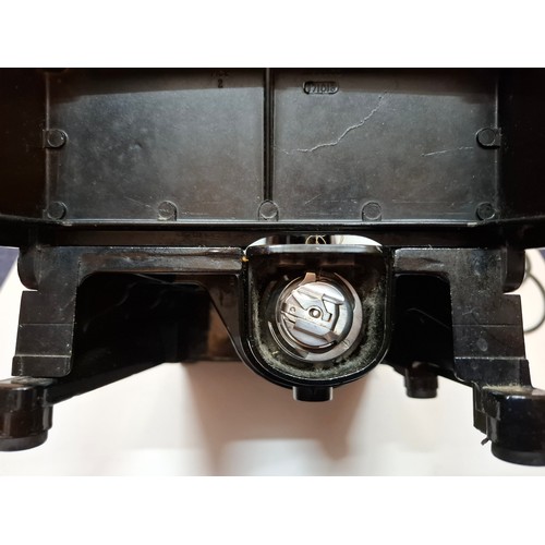 38 - A 1957 Singer Featherweight 222K electric sewing machine having a black travel case together with a ... 