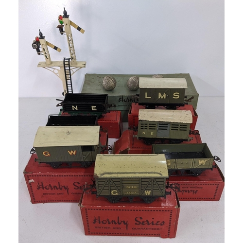42 - Seven boxed Hornby freight carriages, some with N.E. G.W L.M.S markings on the side and a large sign... 
