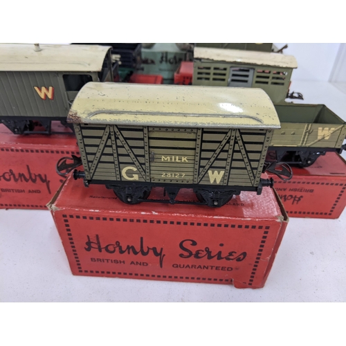 42 - Seven boxed Hornby freight carriages, some with N.E. G.W L.M.S markings on the side and a large sign... 