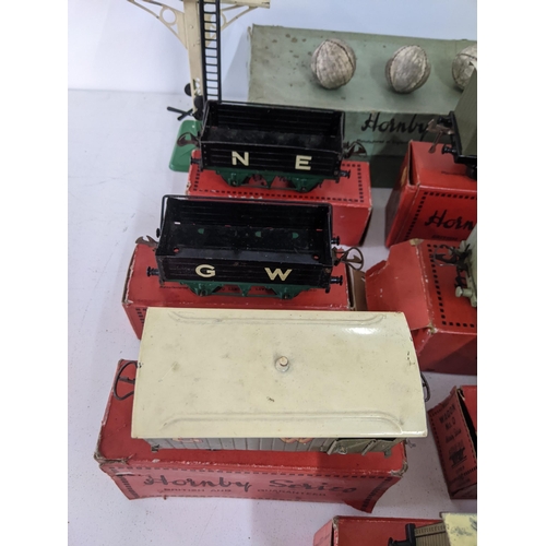 42 - Seven boxed Hornby freight carriages, some with N.E. G.W L.M.S markings on the side and a large sign... 