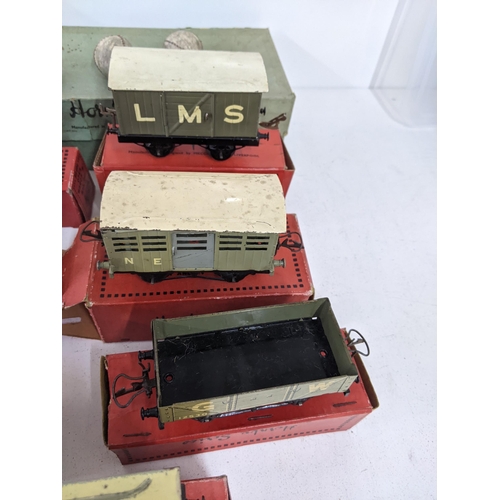 42 - Seven boxed Hornby freight carriages, some with N.E. G.W L.M.S markings on the side and a large sign... 