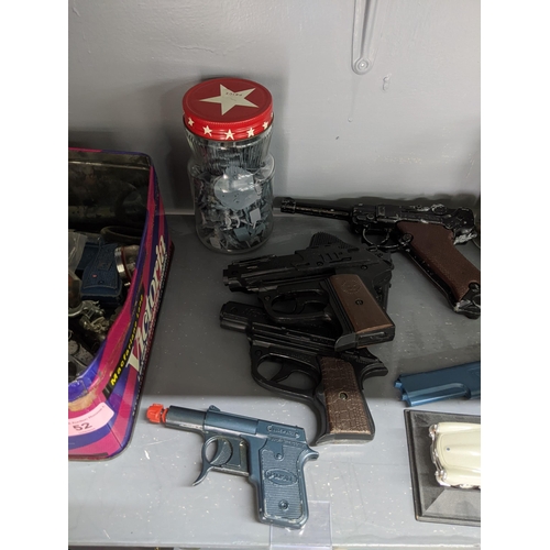 52 - Toy firearms and toy figures to include a model Luger, a Sekiden Automatic SAP 50 model and others
L... 