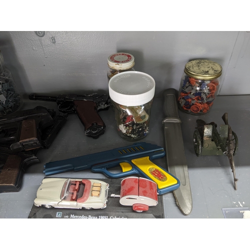 52 - Toy firearms and toy figures to include a model Luger, a Sekiden Automatic SAP 50 model and others
L... 