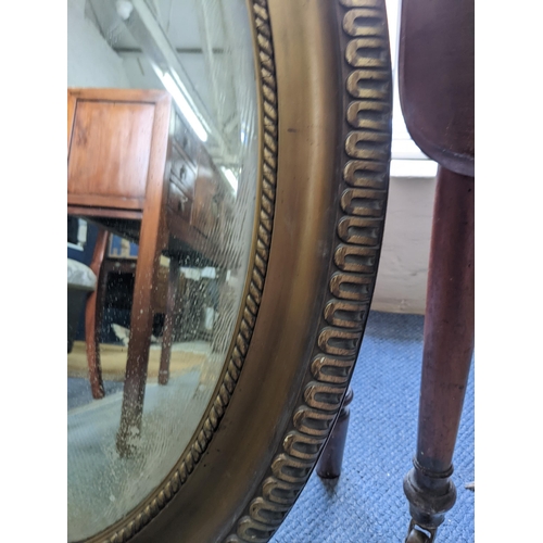 54 - An oval overmantle mirror with a gadrooned border rim supporting the bevelled glass plate
Location:R... 