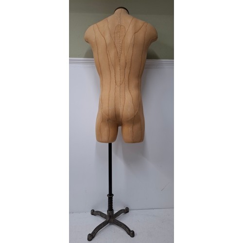 29 - An American Fusion USA tan calico shop mannequin/torso in male form on an adjustable cast metal base... 