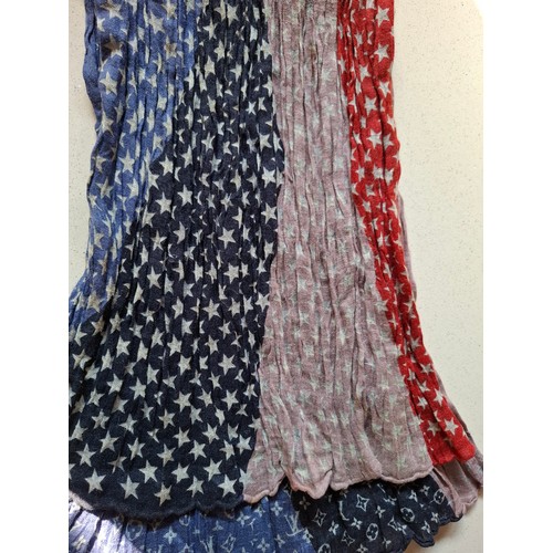 18 - Louis Vuitton- A 2005 ruched silk and linen mix scarf depicting red, white and blue stars and LV mon... 
