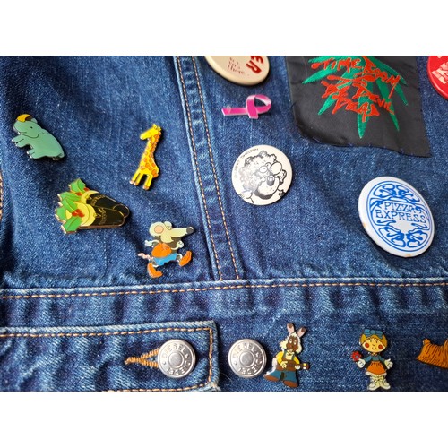 28 - A Diesel Industry denim jacket, size M, covered both front and back in pin badges to include car rac... 