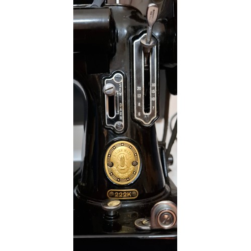 30 - A 1957 Singer Featherweight 222K electric sewing machine having a black travel case together with a ... 