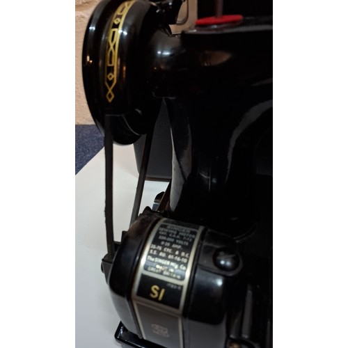 30 - A 1957 Singer Featherweight 222K electric sewing machine having a black travel case together with a ... 