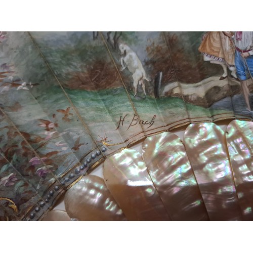 31 - H Bach, Madrid- A 19th century painted fan, the paper leaf decorated with an 18th century goat herde... 