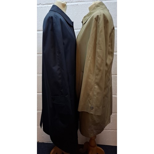 33 - Aquascutum- A navy trench coat, sold at Harrods, size 38 Short, having a tartan lining together with... 