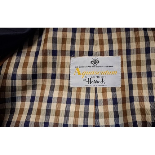 33 - Aquascutum- A navy trench coat, sold at Harrods, size 38 Short, having a tartan lining together with... 