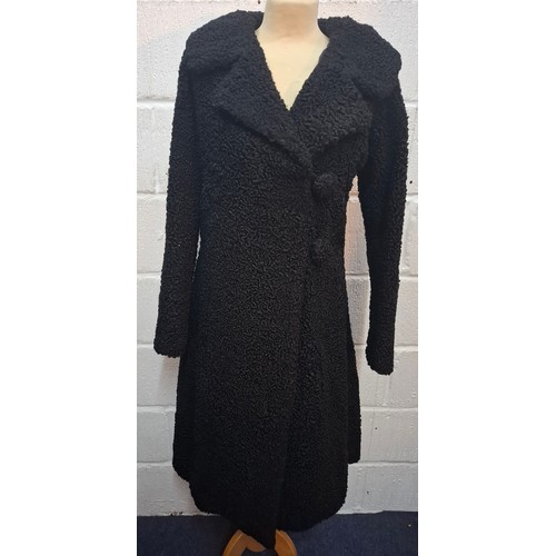 59 - A mid 20th Century black astrakhan swing coat with tapered waistline approx 36