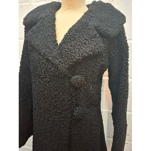 59 - A mid 20th Century black astrakhan swing coat with tapered waistline approx 36