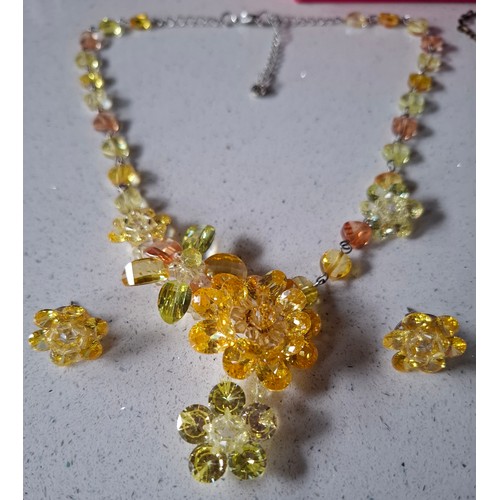 29 - Butler & Wilson- Two floral suites comprising a yellow crystal floral necklace on silver tone chain ... 