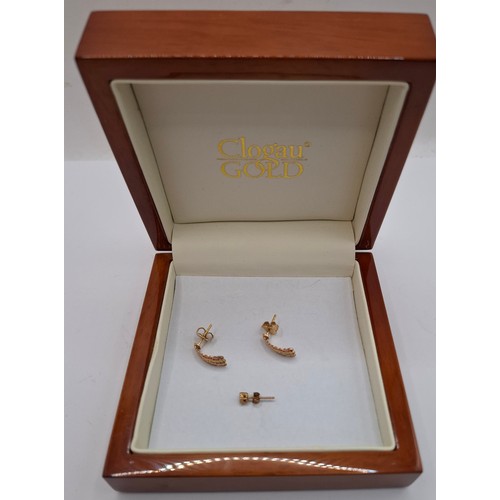 53 - A pair of Clogau 9ct gold and rose gold earrings with 3 inset white stones to each earring having 9c... 